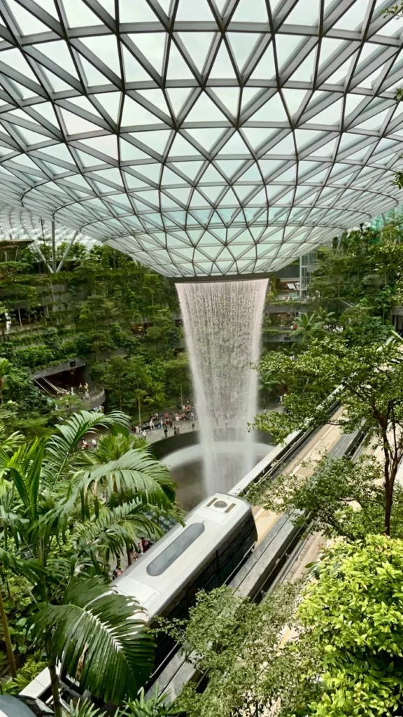 Aerial view of Singapore Changi Airport's lush indoor gardens and terminals.